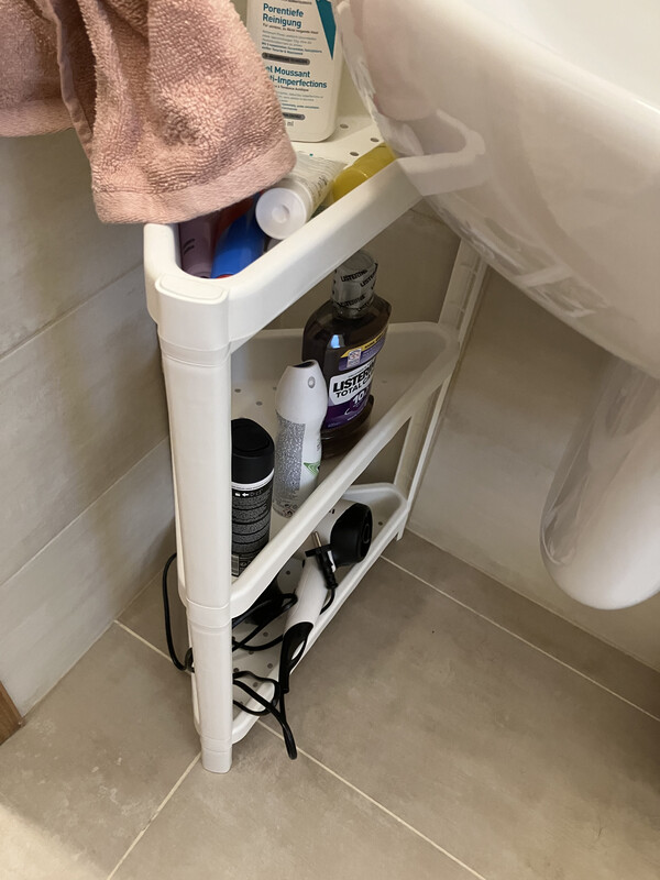 Small white plastic rack in the shower